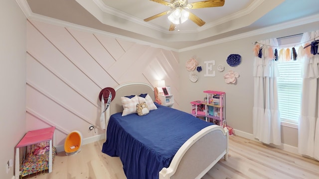 bedroom featuring ornamental molding, ceiling fan, and light hardwood / wood-style flooring