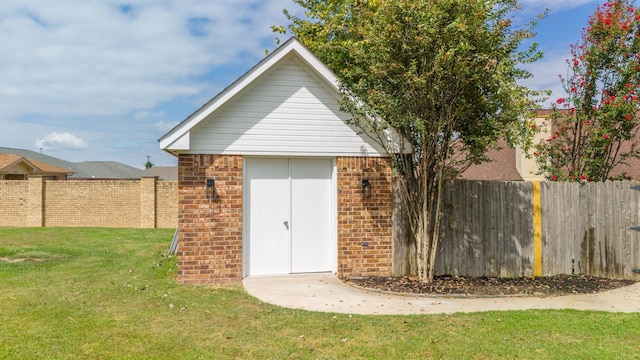 view of outbuilding featuring a lawn