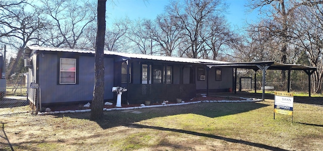 exterior space with a front lawn and a carport