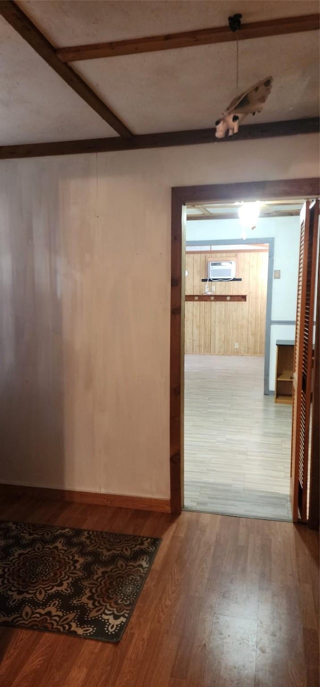 hallway with wood walls and wood-type flooring