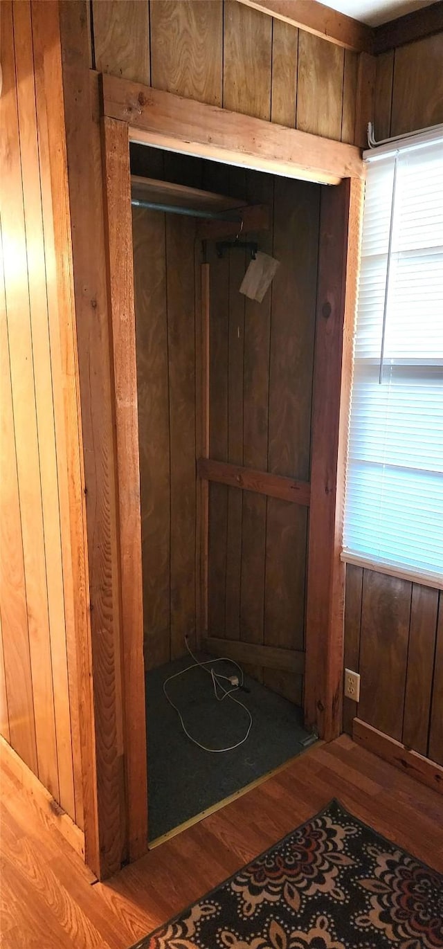 interior space featuring wood walls and hardwood / wood-style flooring