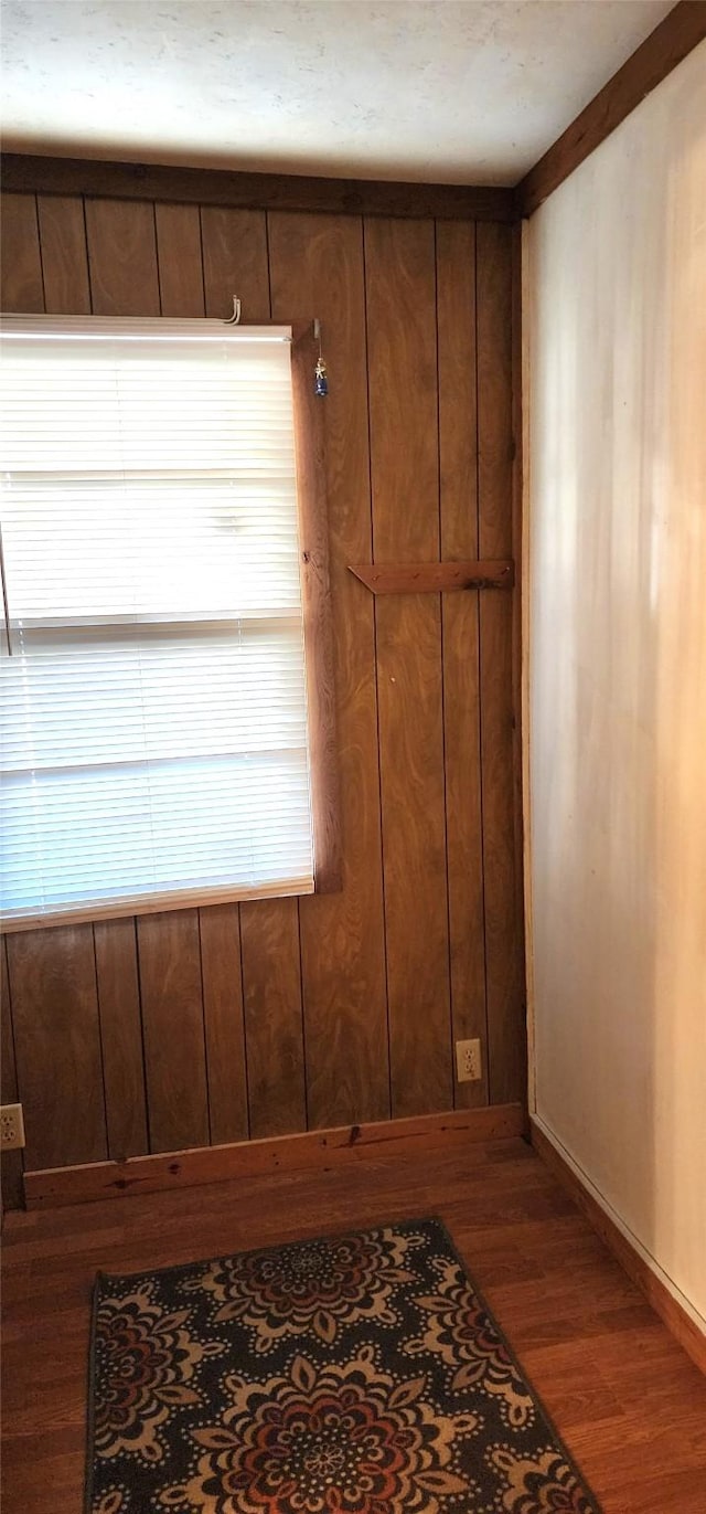 interior details featuring wood-type flooring and crown molding