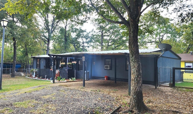 14029 Sitting Bull Dr, Log Cabin, TX 75148 - back of house featuring a gate, metal roof, and a carport