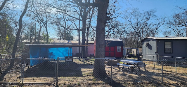 14029 Sitting Bull Dr, Log Cabin, TX 75148 - back of property featuring metal roof and an outdoor structure
