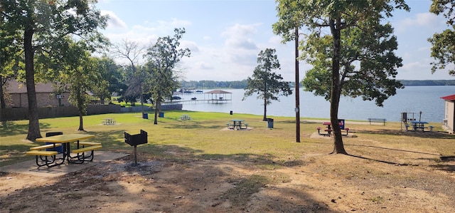 surrounding community with a yard and a water view