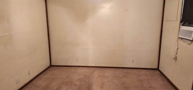 unfurnished room featuring light carpet