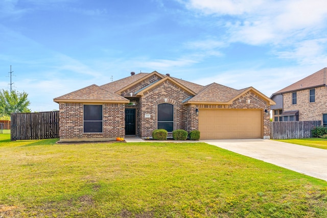 view of front of house featuring a front lawn and a garage