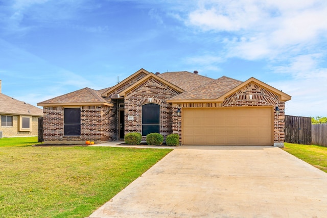 view of front of house featuring a front yard and a garage