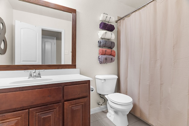 bathroom featuring vanity, toilet, and tile patterned floors