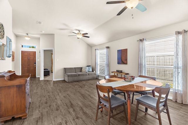 dining area featuring dark hardwood / wood-style floors, ceiling fan, and vaulted ceiling