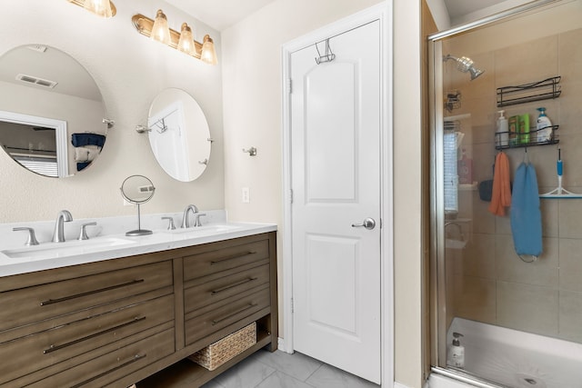 bathroom with vanity and a shower with shower door