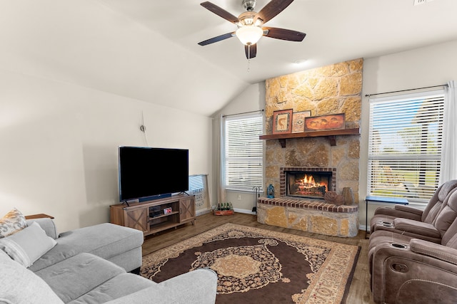 living room with vaulted ceiling, a fireplace, wood-type flooring, and ceiling fan