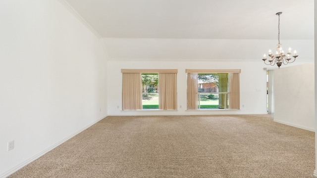 carpeted empty room with crown molding and a chandelier