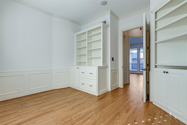 interior space featuring crown molding and light hardwood / wood-style flooring