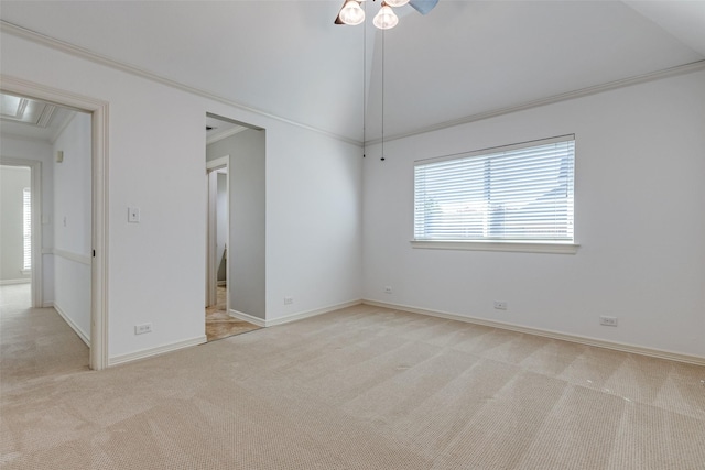 empty room with ceiling fan, ornamental molding, vaulted ceiling, and light carpet