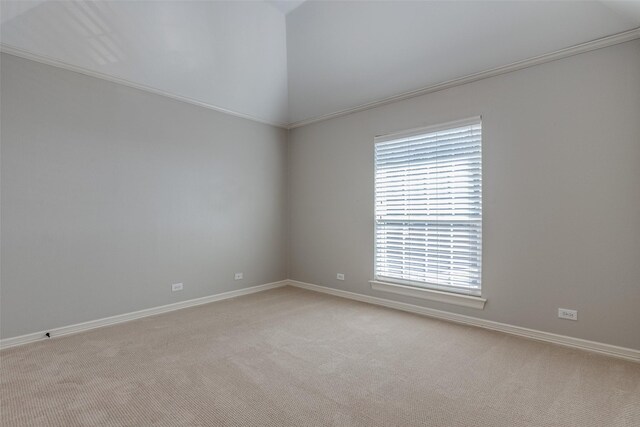 carpeted spare room with lofted ceiling, ornamental molding, and ceiling fan