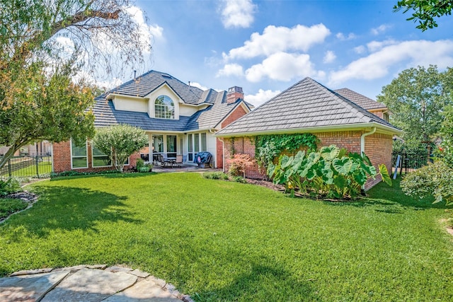 view of front facade with a patio and a front yard