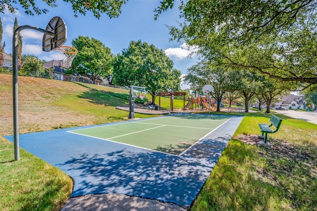 view of basketball court featuring a yard, a pergola, and a playground