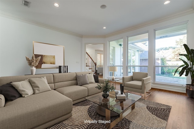 living room with hardwood / wood-style floors and ornamental molding