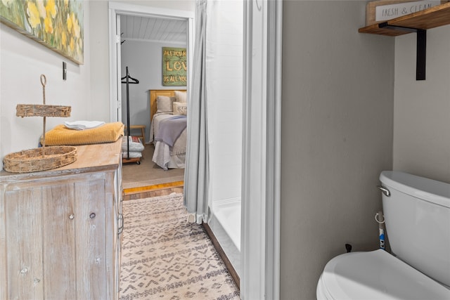 bathroom featuring curtained shower and toilet