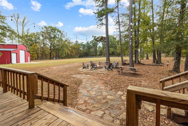 deck with an outdoor structure and an outdoor fire pit