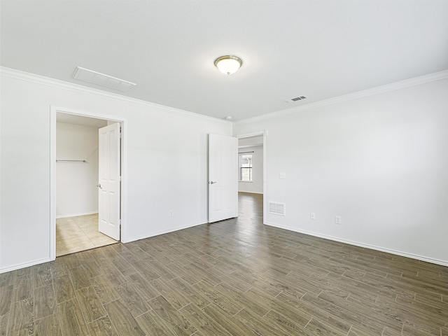 interior space featuring crown molding and dark wood-type flooring