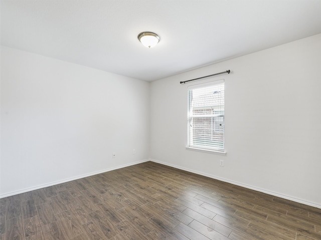 unfurnished room with dark hardwood / wood-style floors