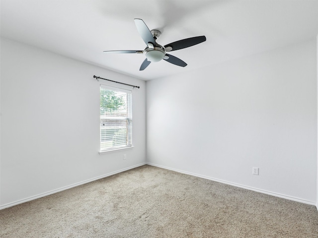 empty room with ceiling fan and carpet