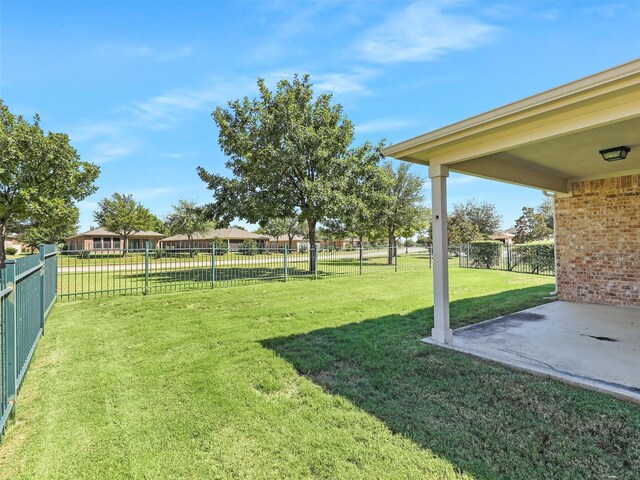 rear view of property featuring a lawn and a patio