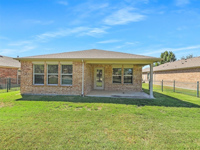 rear view of house featuring a yard and a patio