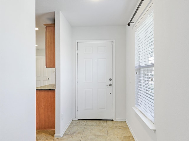 doorway to outside featuring light tile patterned flooring