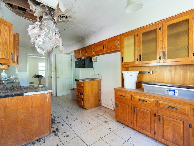 kitchen featuring a textured ceiling and light tile patterned flooring