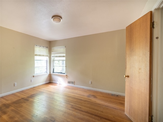 unfurnished room featuring light hardwood / wood-style floors