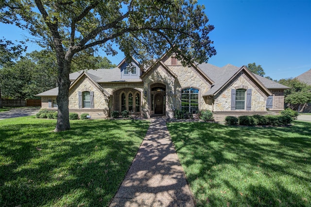 french country home with a front lawn