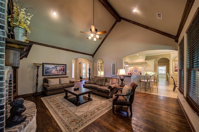 living room featuring ceiling fan, hardwood / wood-style floors, high vaulted ceiling, and a wealth of natural light