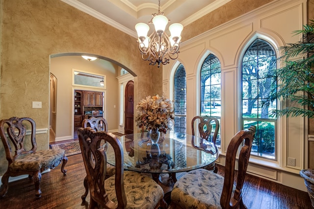 dining area featuring a healthy amount of sunlight, ornamental molding, and dark hardwood / wood-style floors