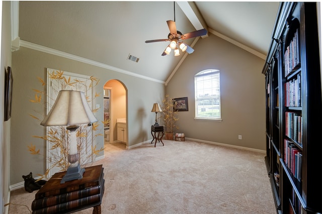 living area featuring vaulted ceiling with beams, ornamental molding, light carpet, and ceiling fan