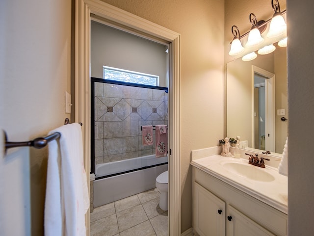 full bathroom with tile patterned flooring, toilet, vanity, and combined bath / shower with glass door