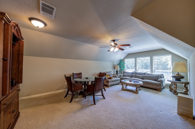 interior space featuring ceiling fan, a textured ceiling, and vaulted ceiling