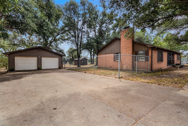 view of property exterior with a garage and an outbuilding