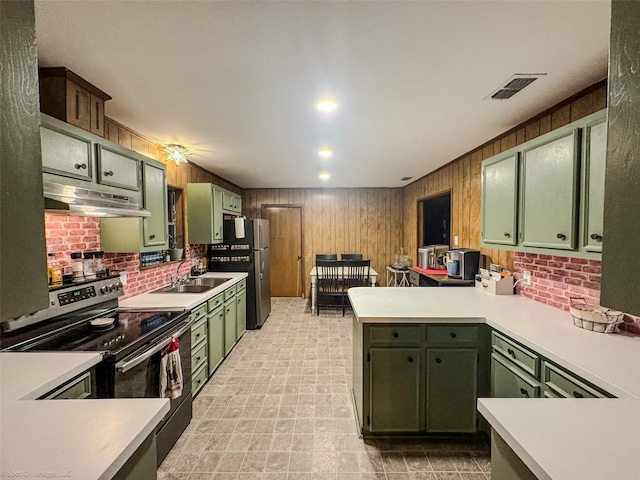 kitchen featuring electric range oven, kitchen peninsula, stainless steel fridge, and green cabinetry