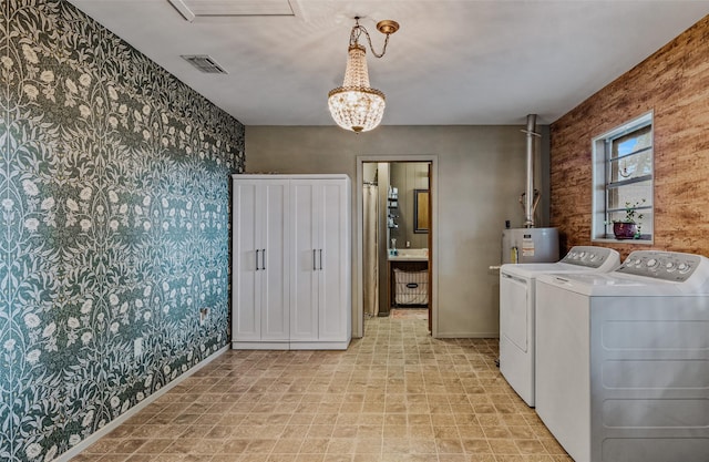 laundry area featuring water heater and separate washer and dryer