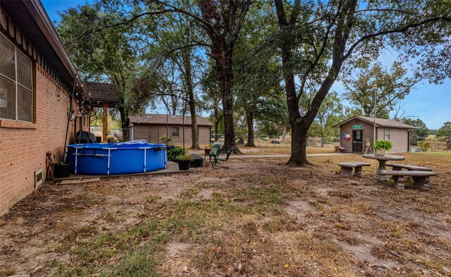 rear view of property featuring a swimming pool and a patio