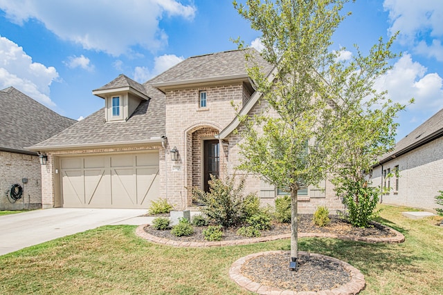 view of front of property featuring a garage and a front lawn