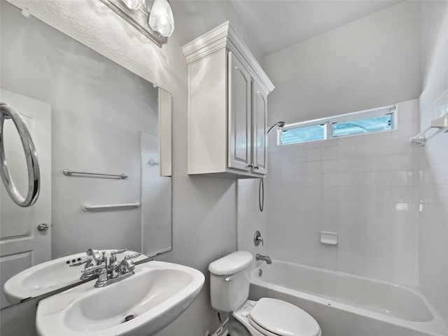 full bathroom featuring tiled shower / bath, sink, and toilet