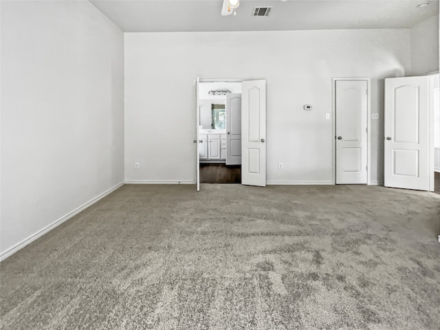 unfurnished room featuring dark carpet