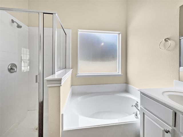 bathroom with vanity and separate shower and tub