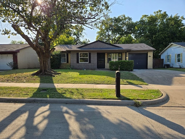 ranch-style house featuring a front lawn and a garage