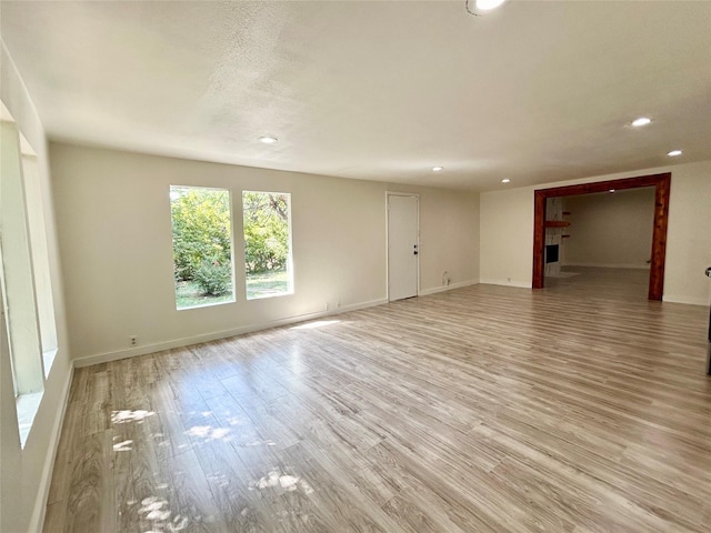 1526 Daniel Dr, Arlington, TX 76010 - unfurnished living room with recessed lighting, a fireplace, light wood-style floors, and baseboards