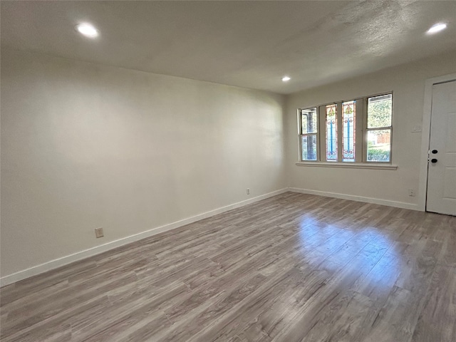 spare room with light hardwood / wood-style flooring